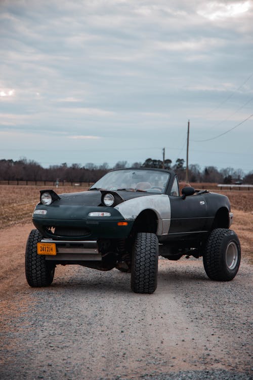 Convertible Car Parked on Dirt Road