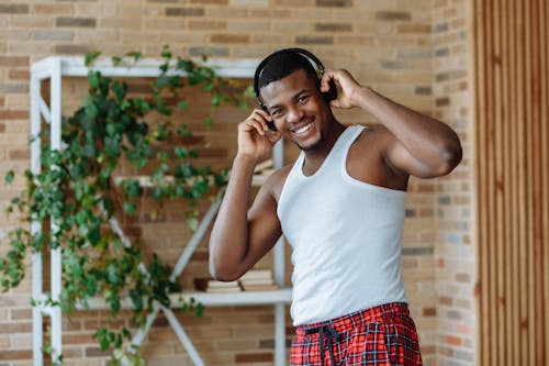 A Smiling Man Wearing Wireless Headphones