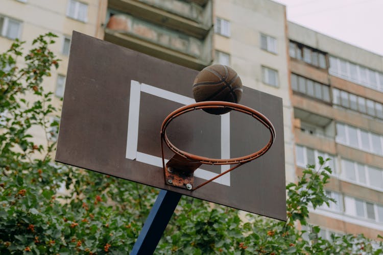 Brown Basketball Suspended Above The Hoop 