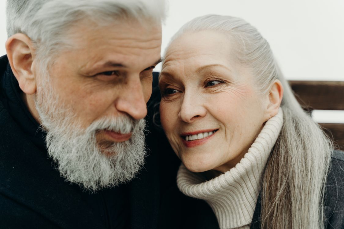 Senior couple smiling warmly together in an intimate embrace