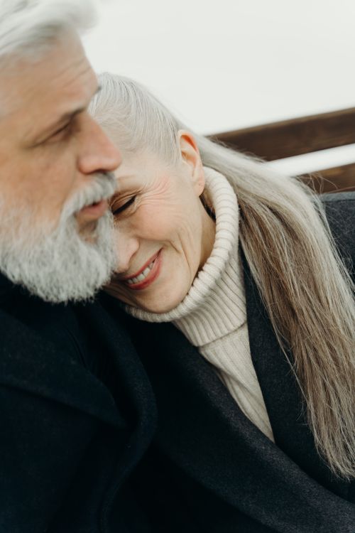 Free Warm embrace of a senior couple with grey hair, showcasing love and togetherness. Stock Photo
