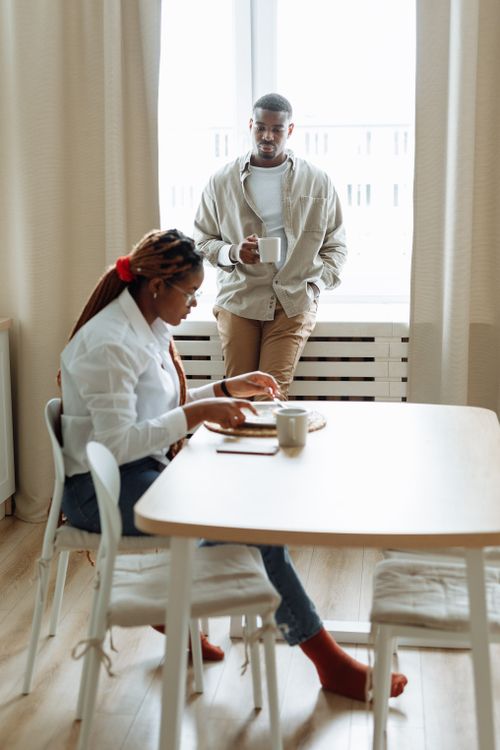Free A couple shares a relaxing morning coffee at home, embodying a cozy lifestyle. Stock Photo
