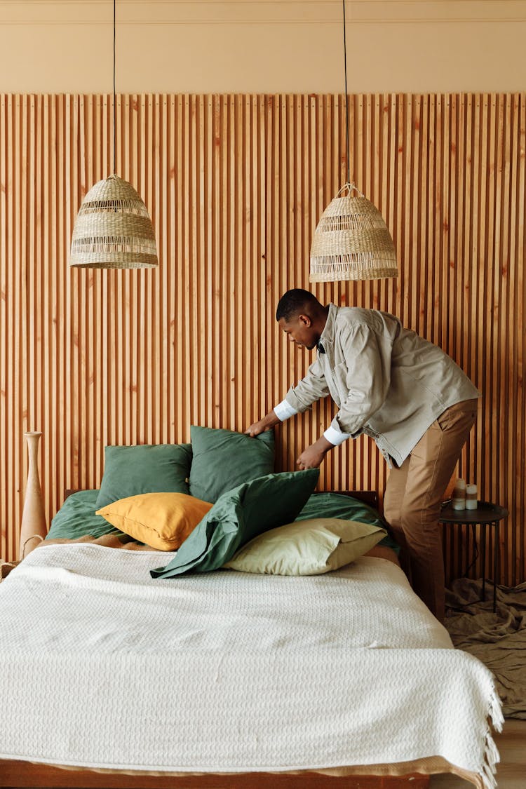 A Man Fixing A Bed 