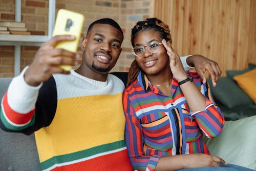 Photo of a Man Taking a Photo with a Woman in a Colorful Shirt