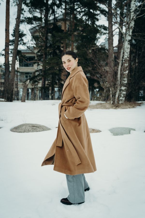 Woman in belted wool crepe wrap dress