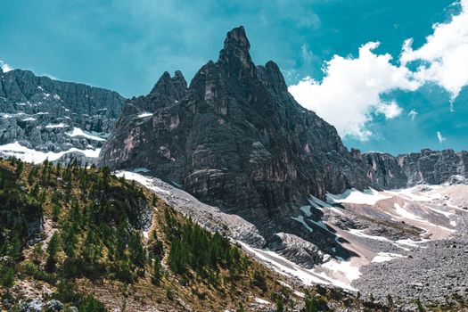Stunning view of the Dolomites in Veneto, Italy, with snow-capped peaks and clear blue sky.