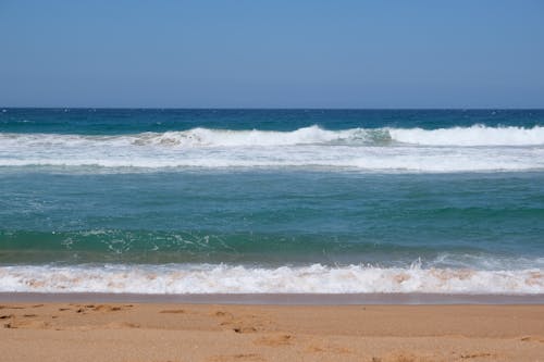 Sea Waves Crashing on a Sandy Shore