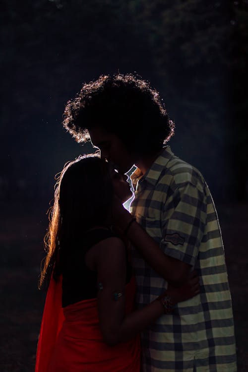 Photo of a Man Kissing a Woman's Forehead