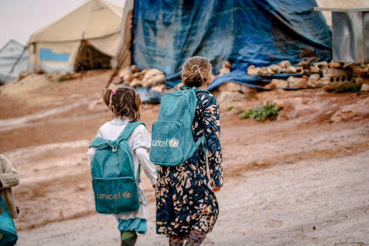 Photograph Of Children With Blue Backpacks Walking