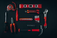 Composition of assorted service instruments on black surface