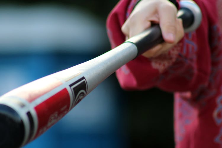 Close-Up Shot Of A Person Holding A Baseball Bat