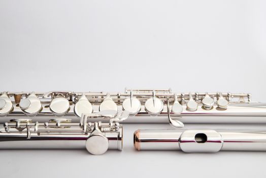 Detailed shot of elegant silver flutes showcasing musical craftsmanship and design.