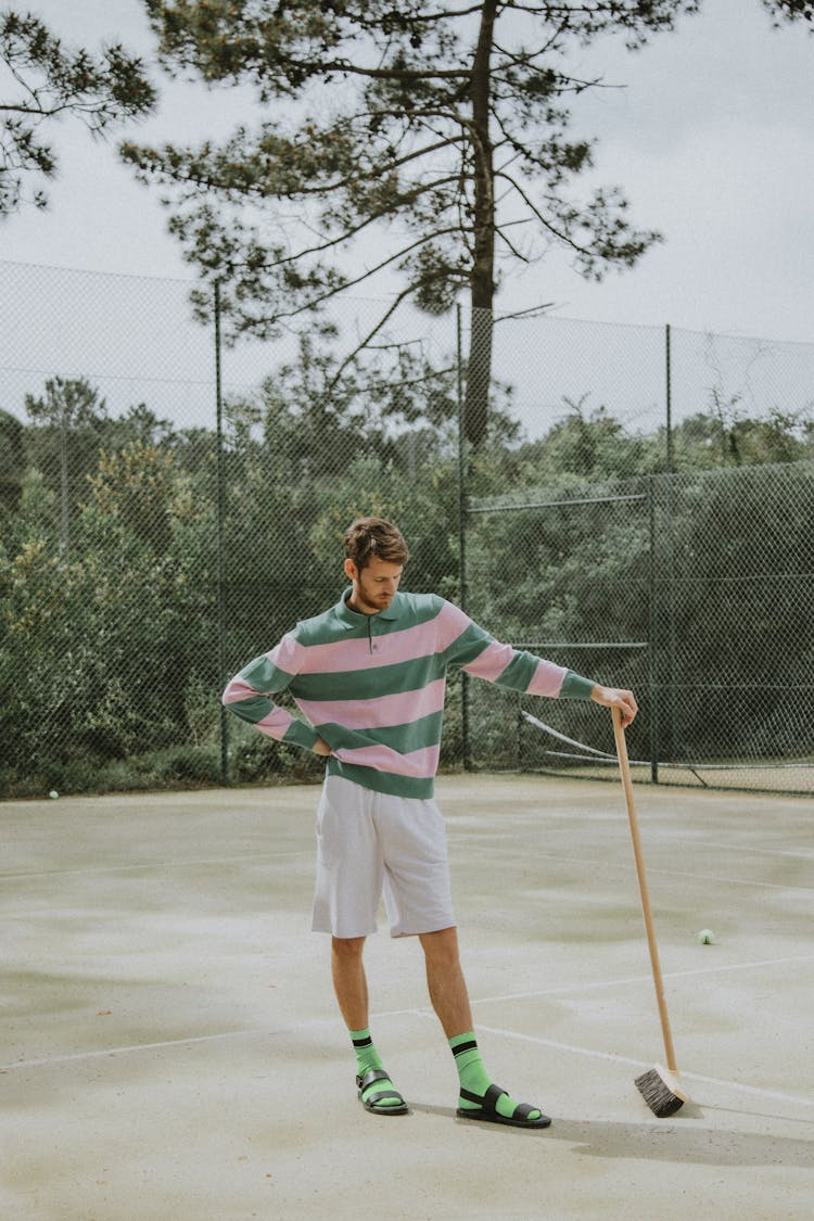 A Man Standing On The Tennis Court