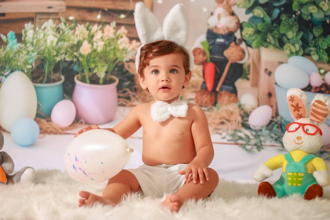 Photograph of a Baby with Bunny Ears Sitting on a Fur Carpet