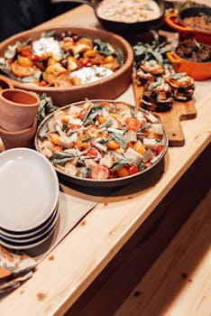 A beautifully arranged dining table featuring vibrant salads and rustic dishware for a festive meal.