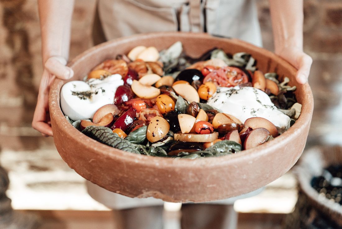 Rustic salad of fresh fruit, greens and crumbled cheese in a bowl. Photo by furkanfdemir on Pexels