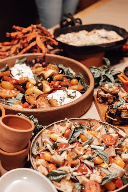 Free Delicious spread of rustic vegetable salads with artisan bread, exuding a warm organic feel. Stock Photo