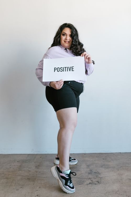 Free Plus-size woman holding a sign promoting body positivity and self-love. Stock Photo