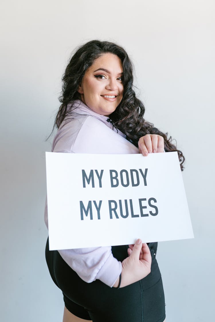 Woman Holding A Sign While Posing