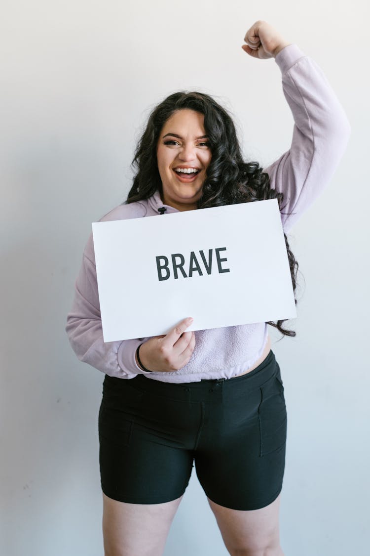 A Woman Holding A Brave Sign