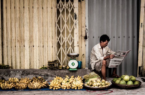 Free Man Sitting Near Fruits Stock Photo