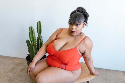 Empowering image of a plus-size woman embracing body positivity in a vibrant red swimsuit.