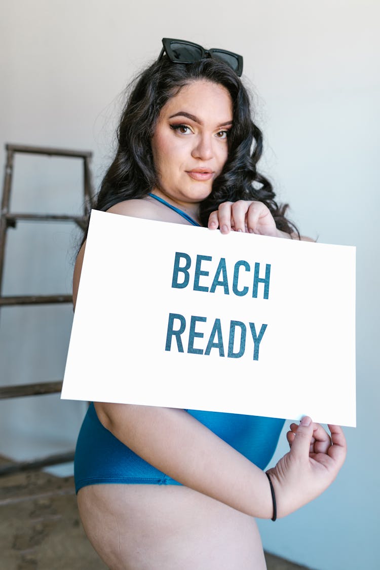 Woman Holding A Beach Ready Sign