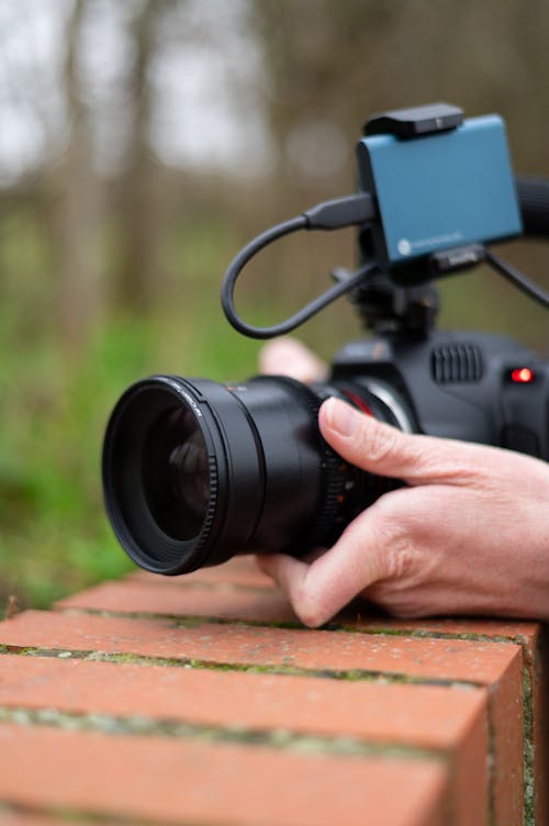 A Person Holding Black Camera