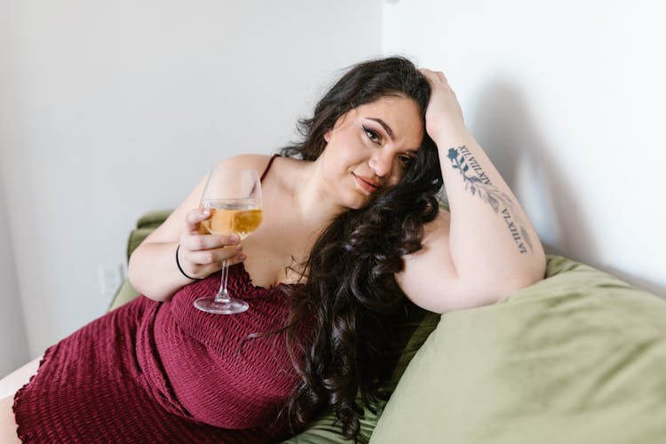 Woman  In Maroon Dress Holding A Drink