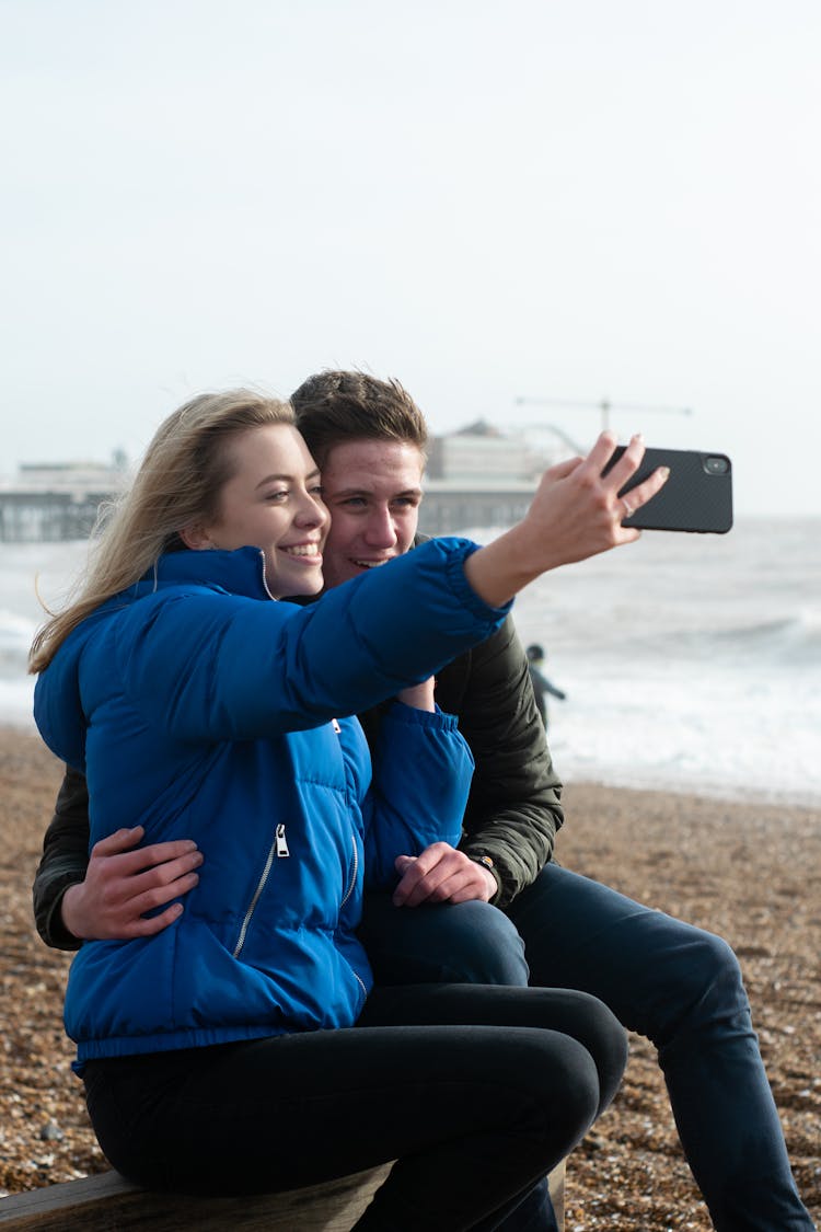 A Romantic Couple Taking Selfie On The Beach