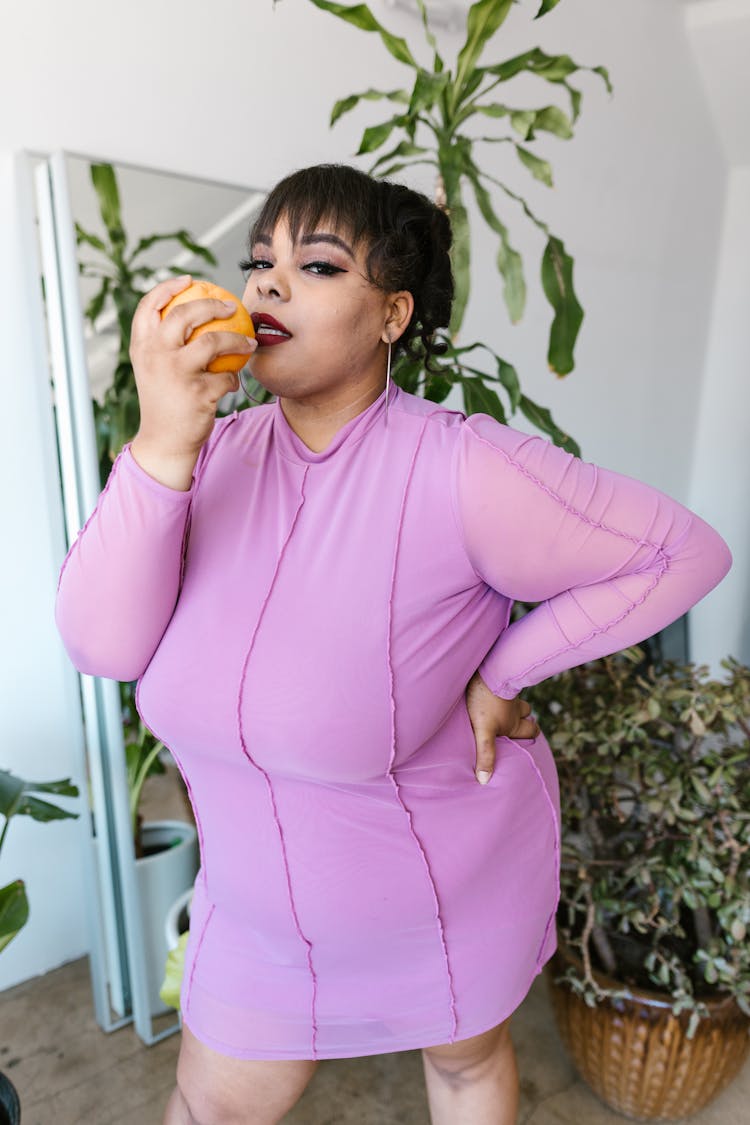 A Woman Holding Orange Fruit