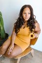 Woman in Yellow Tank Top and Yellow Shorts Sitting on Gray Couch