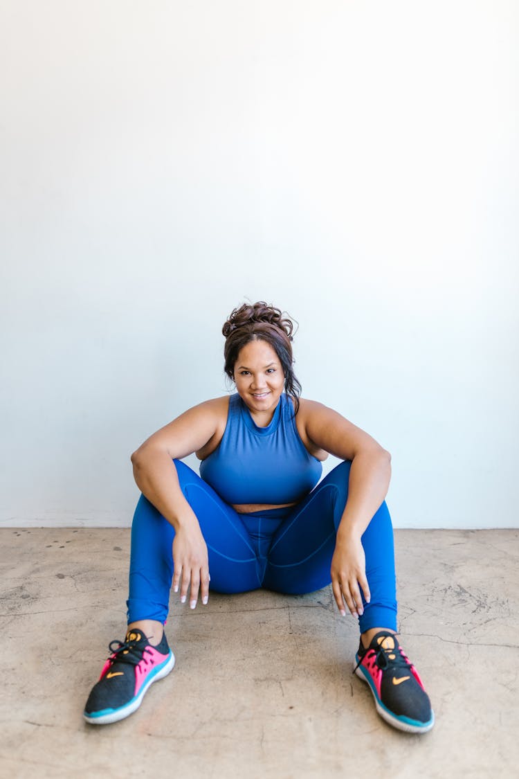 Smiling Woman Sitting On The Floor