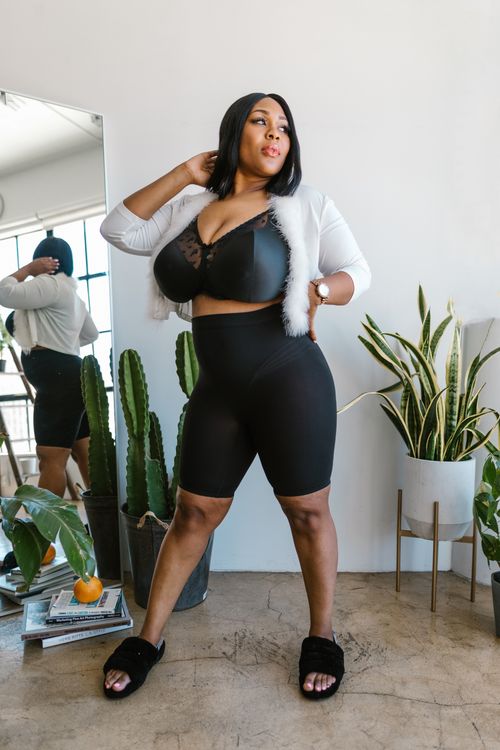 Free A fashionable plus size woman posing confidently indoors with plants. Stock Photo