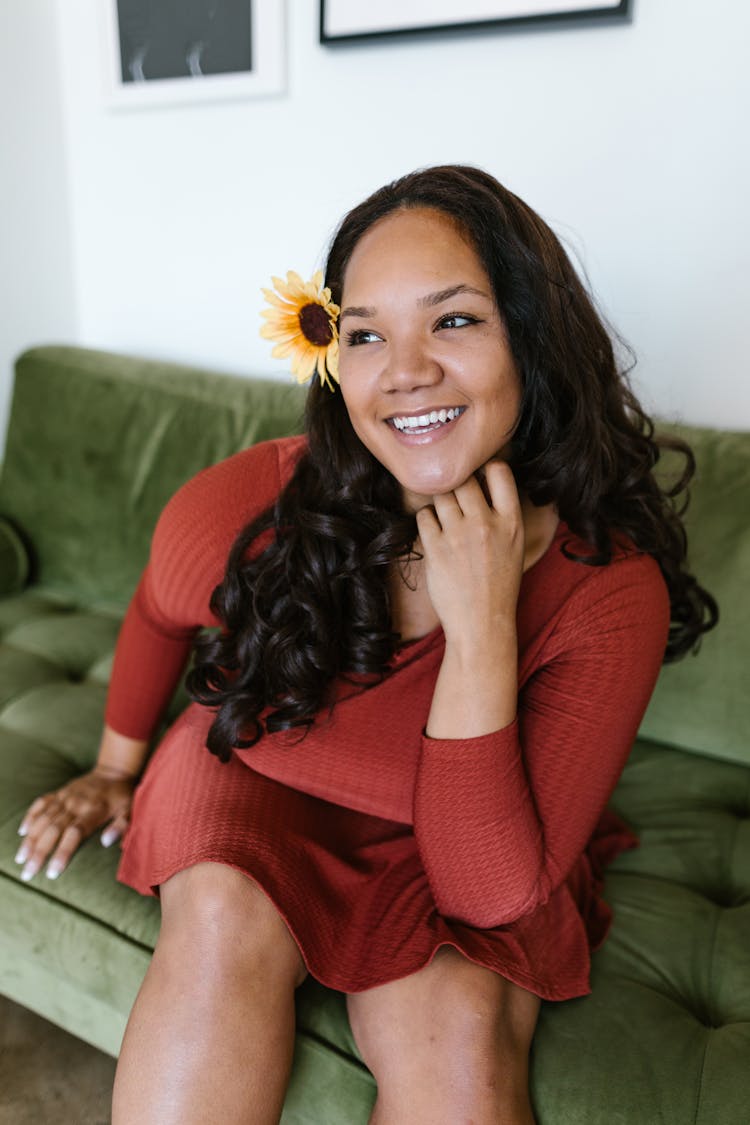 Woman In Red Dress Sitting On Green Couch