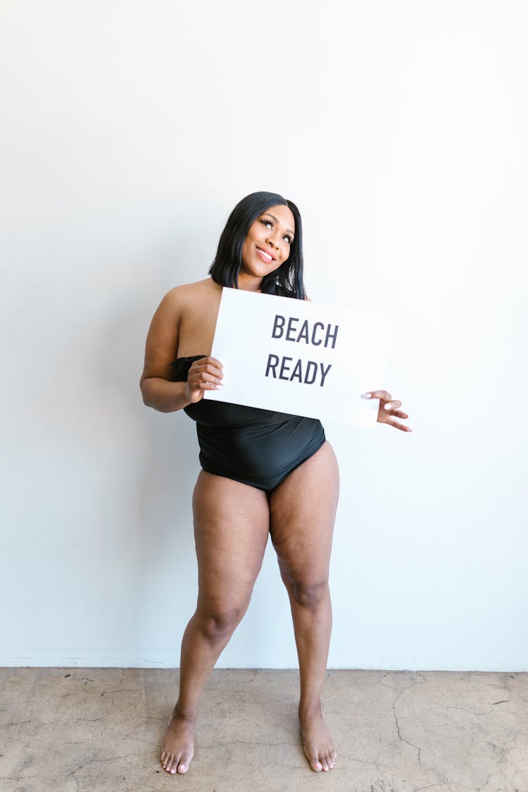 Woman In Tube Swimsuit Holding White Paper