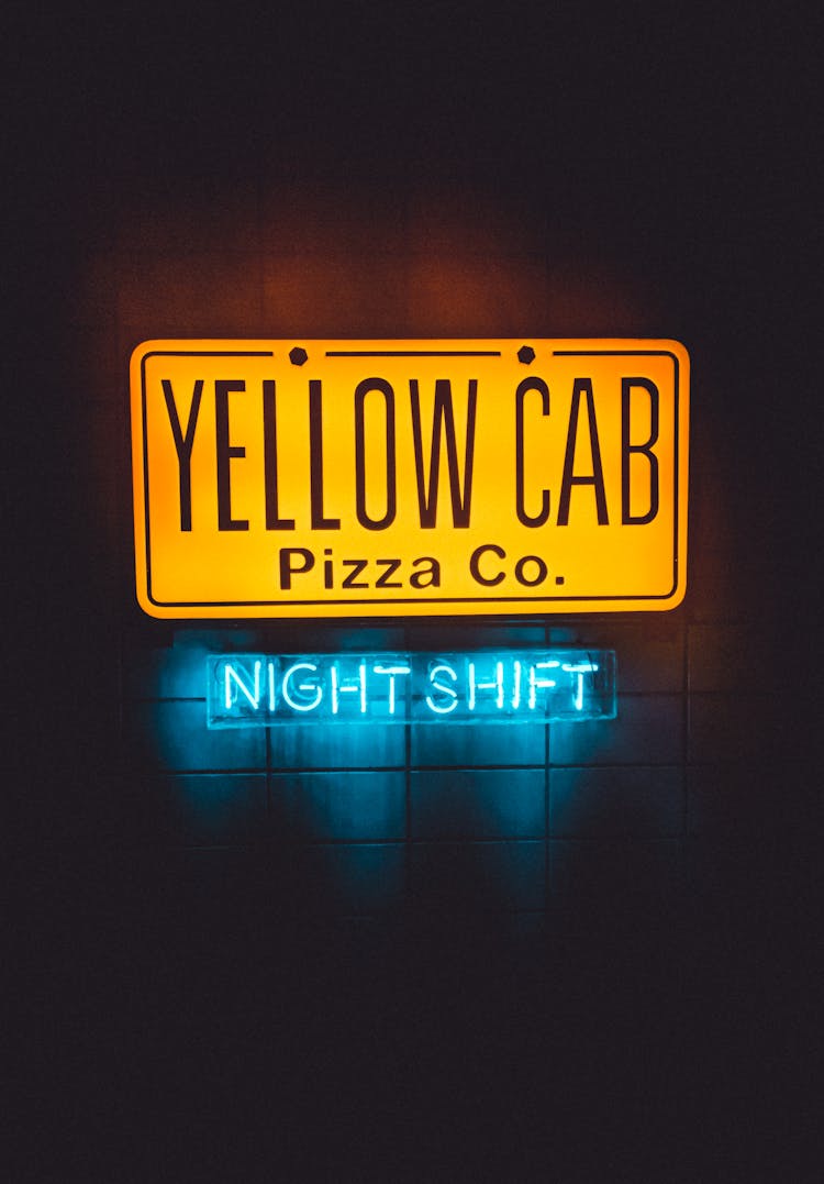 Glowing Signboard Of Pizzeria In Night Time