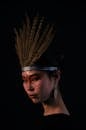 Woman with Face Paint Wearing a Feather Headdress