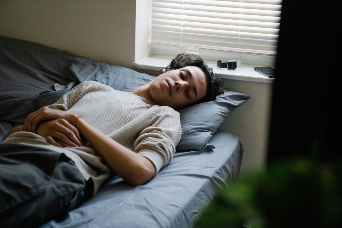 Adult man sleeping peacefully in a comfortable bedroom