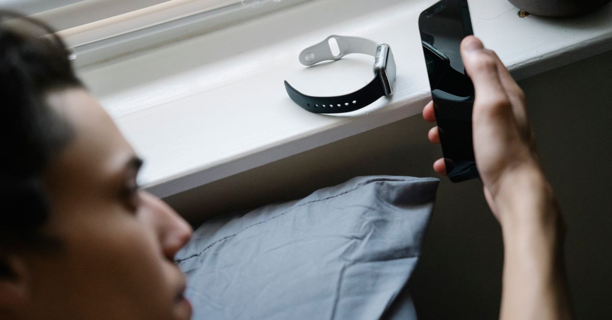 person putting smartphone in drawer, calm morning light
