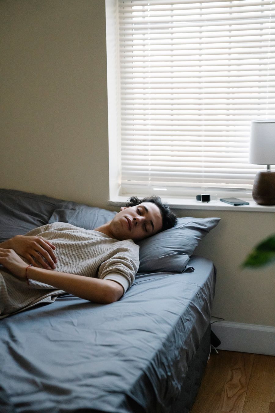 Adult resting in a calm bedroom during early meth recovery and sleep stabilization