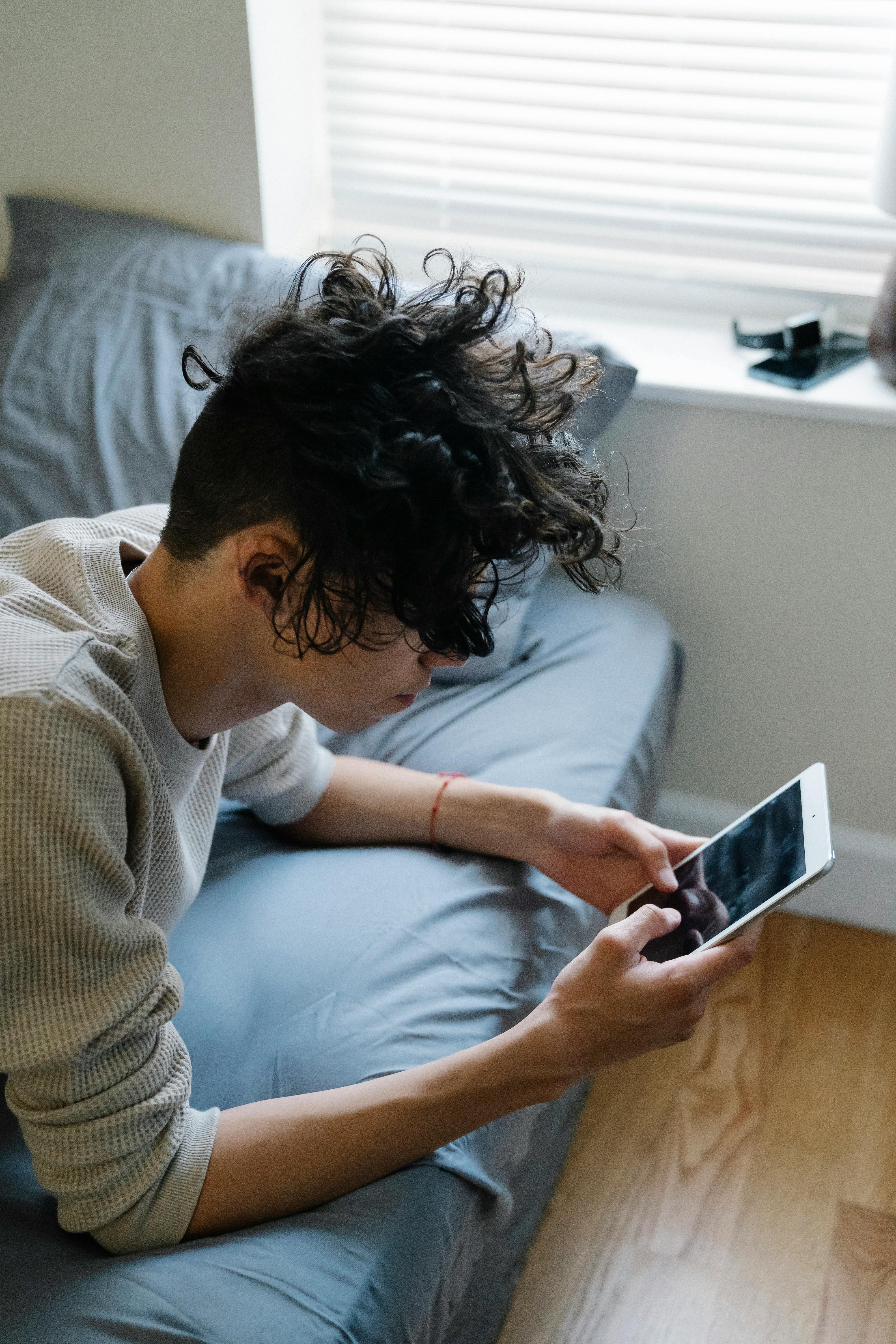 young guy texting on mobile phone