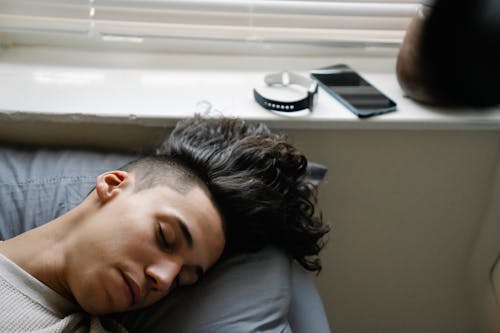 Young Hispanic man sleeping in morning