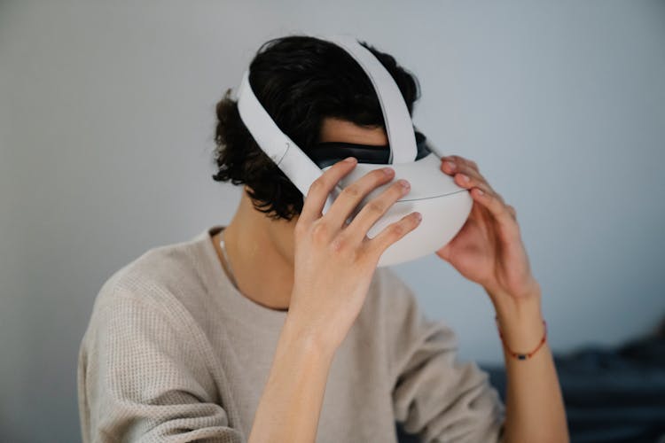 Anonymous Young Man Putting On VR Headset