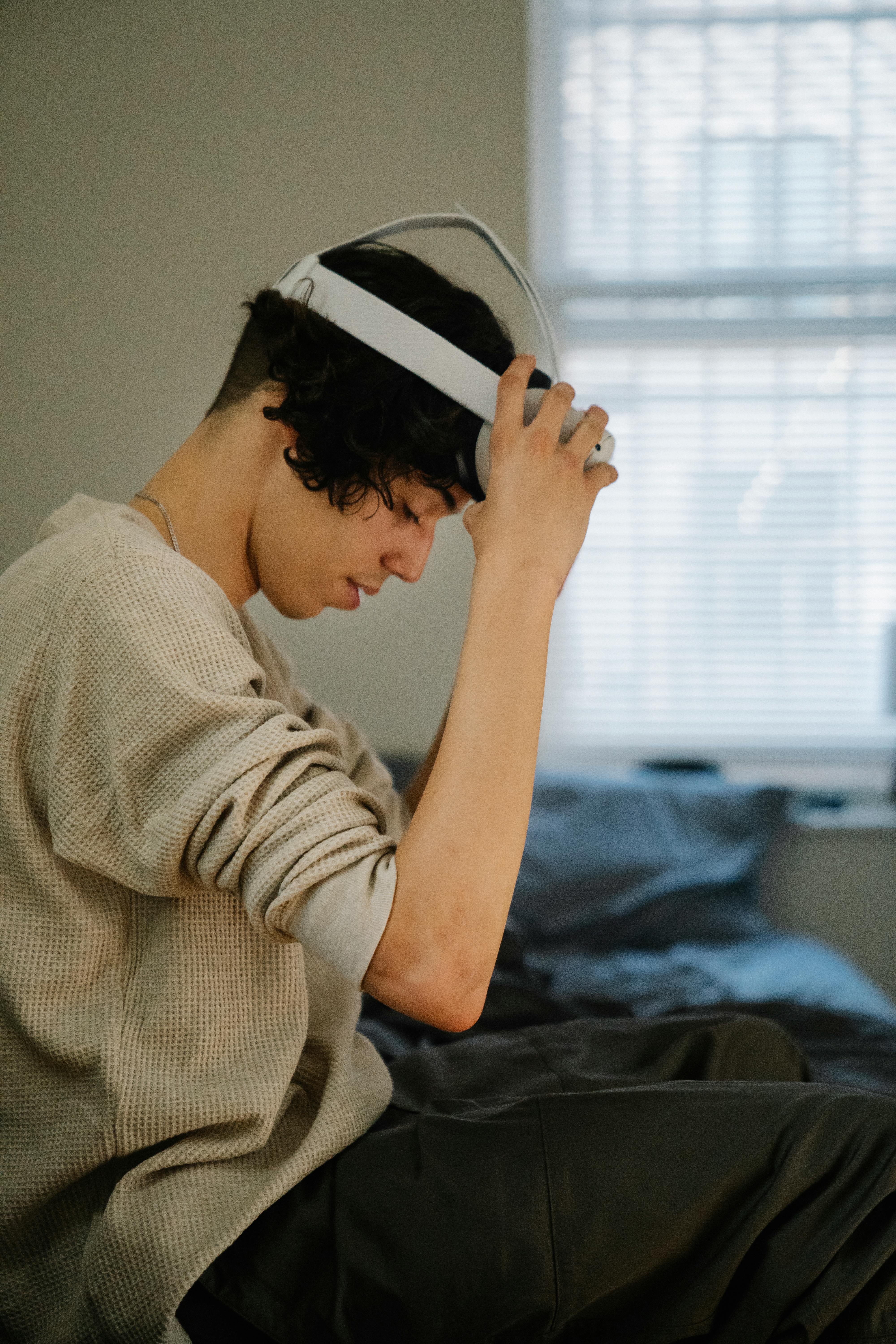 young hispanic guy putting on vr headset