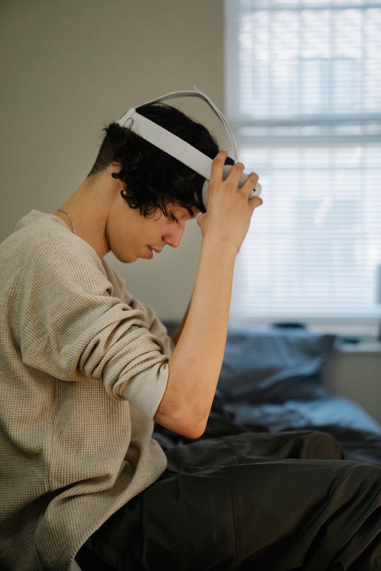 Young Hispanic Guy Putting On VR Headset