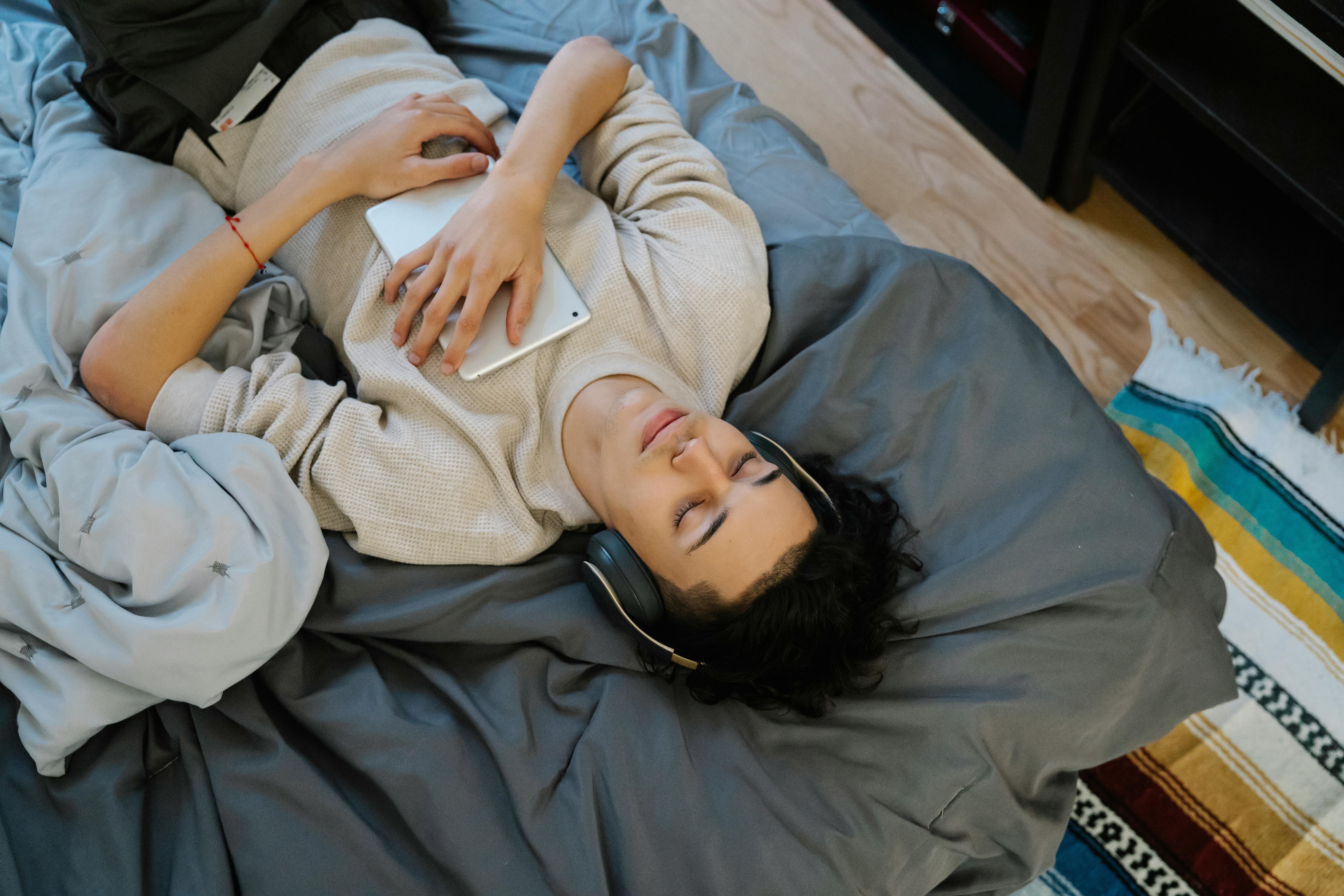 young male listening to music with closed eyes