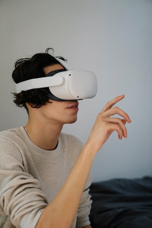 Amazed young man experiencing virtual reality in contemporary headset