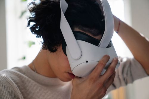 Free Close-up of a young adult using a VR headset indoors. Stock Photo