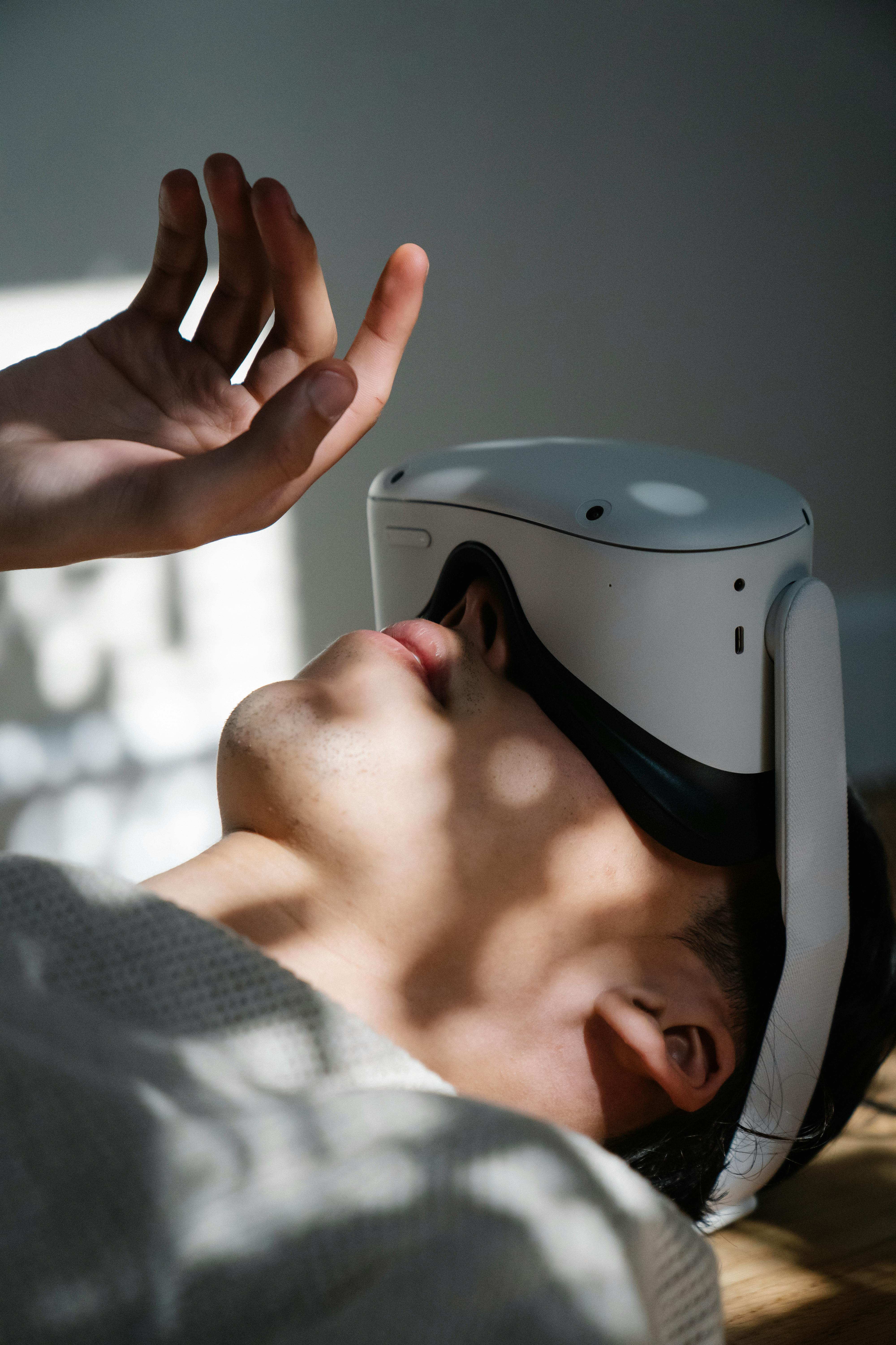 a man wearing a virtual reality headset while lying down